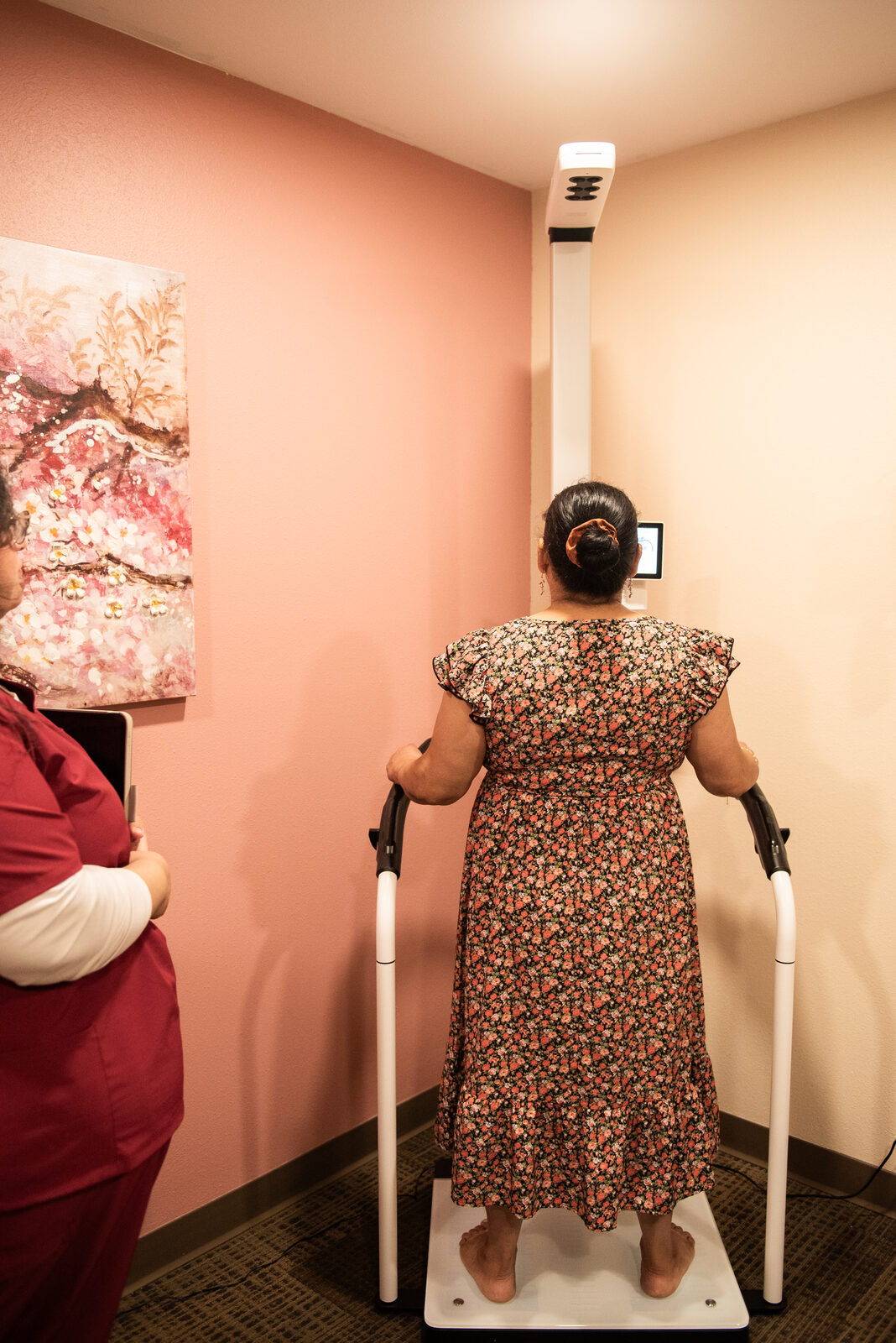 Patient standing on the body composition analyzer
