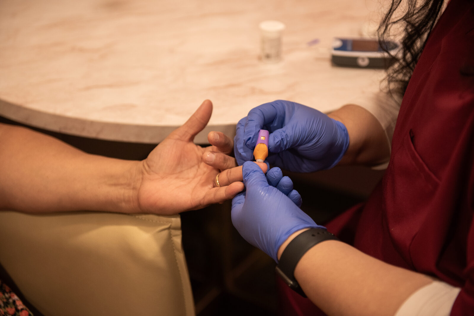 Finger-prick glucose check at the clinic